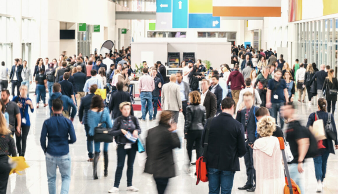 Large,Crowd,Of,Anonymous,Blurred,People,At,A,Trade,Fair