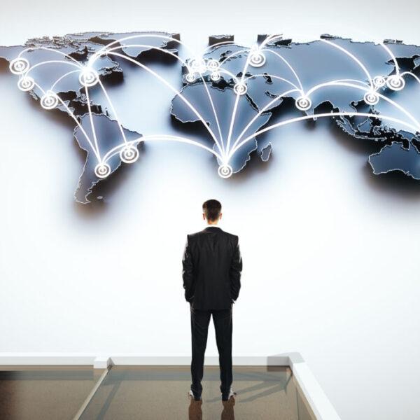 Global,Social,Networking,Concept,With,Businessman,Looking,At,Abstract,Map