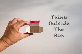 Word,,Think,Outside,The,Box,Next,To,Fingers,Holding,An